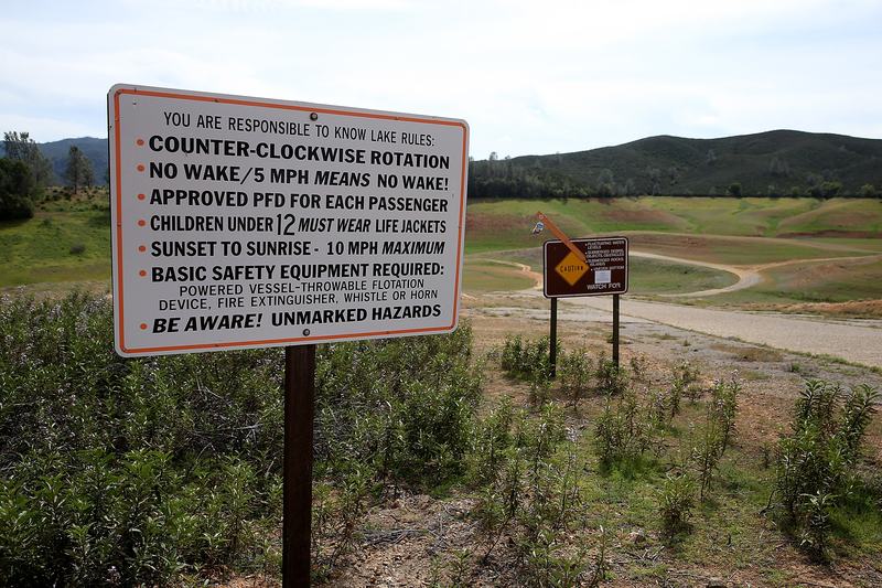 Signs with instructions for boaters remain in a completely dry section of Lake McClure on March 24, 2015 in Coulterville, California. Lake McClure is currently at 7 percent of its normal capacity.