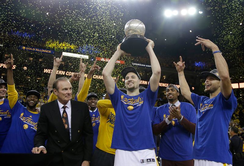 Klay Thompson of the Golden State Warriors hoists the Western Conference Championship Trophy after defeating the Oklahoma City Thunder in Game Seven of the Western Conference Finals.