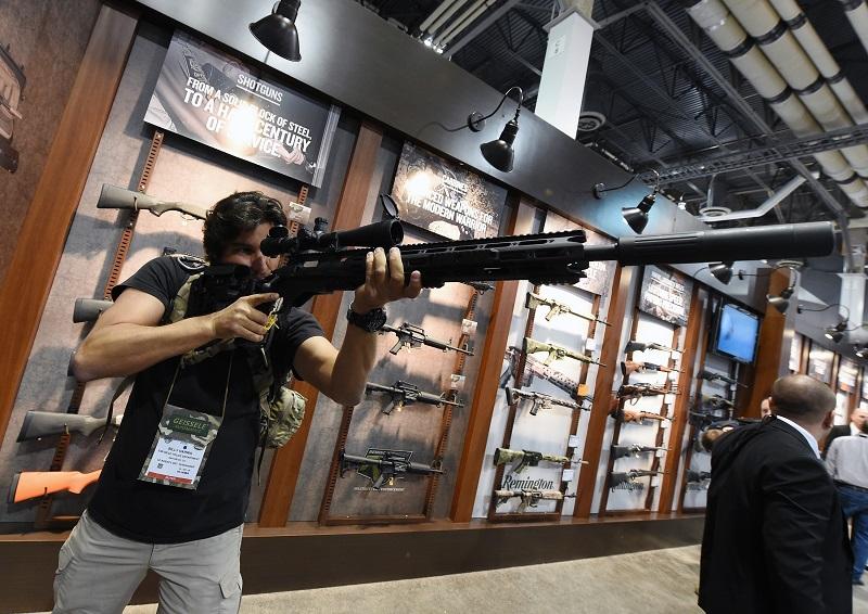 Billy Harris tries out a .308 caliber rifle at the Remington booth at the 2016 National Shooting Sports Foundation's Shooting, Hunting, Outdoor Trade (SHOT) Show  on January 19, 2016 in Las Vegas, NV.