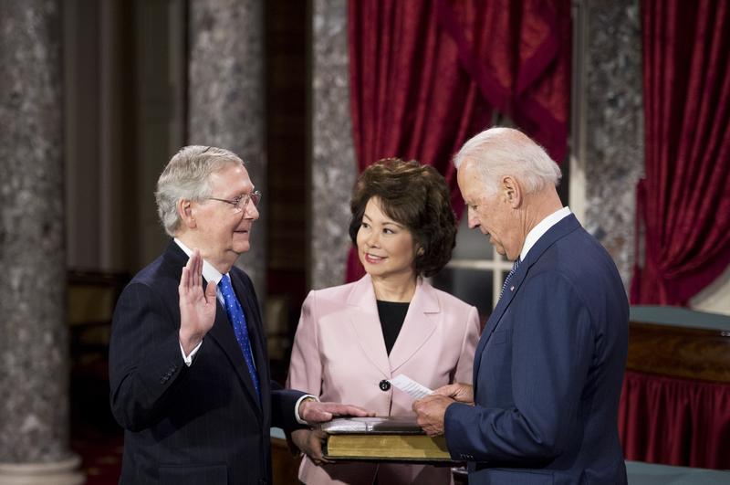  Senate Majority Leader Mitch McConnell, R-Ky., his wife Elaine Chao and Vice President Joe Biden participate in the re-enactment swearing-in ceremony on Tuesday, Jan. 6, 2015. 