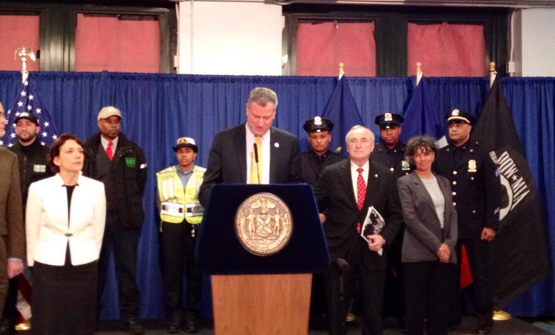 NYC Mayor Bill de Blasio, flanked by DOT commissioner Polly Trottenberg (L) and NYPD head William Bratton (R)