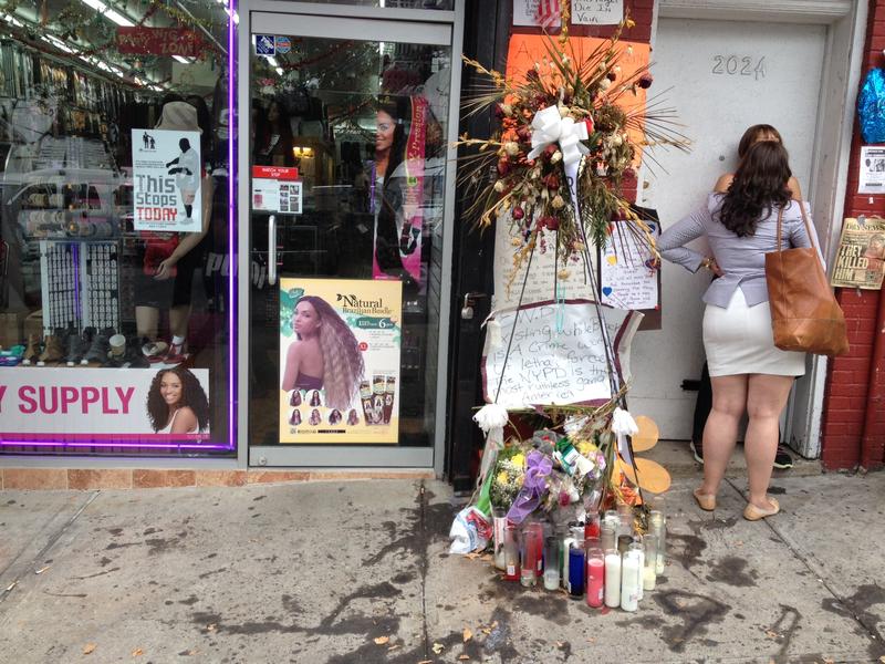 People gather at the scene of Eric Garner's death shortly father the medical examiner ruled it a homicide. 