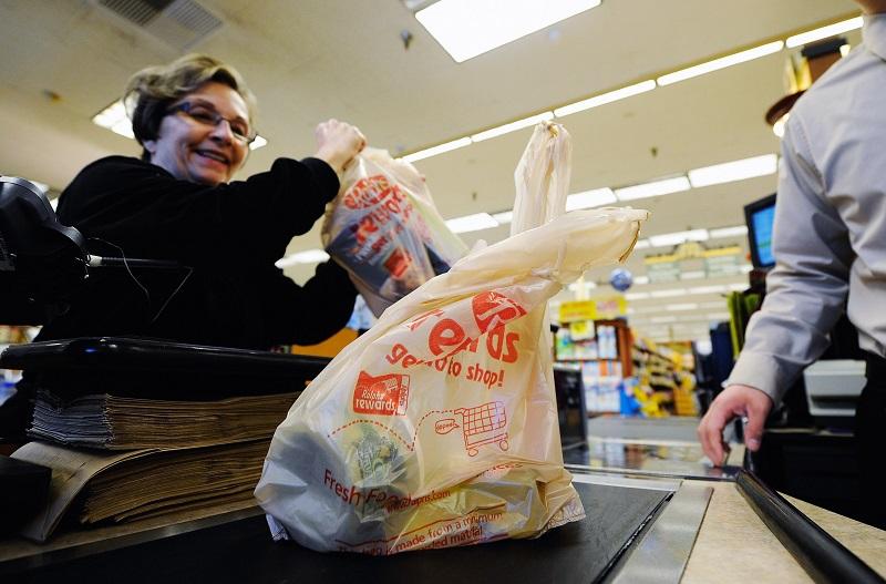 Customers of Ralphs supermarket use plastic bags to carry their groceries home on October 25, 2011 in Glendale, California.