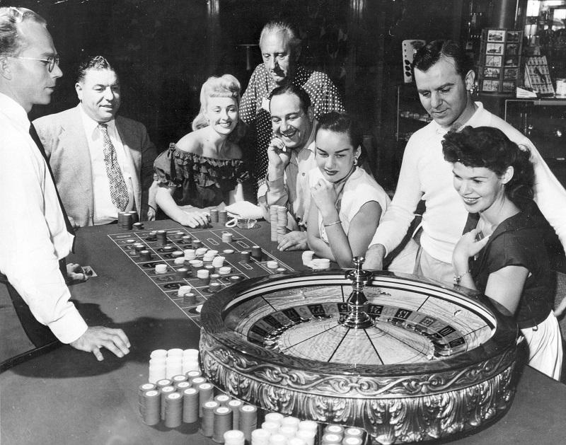 People are shown at one of the gaming tables at the Flamingo Casino in Las Vegas, Nev., May 24, 1955. 