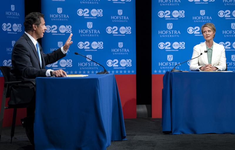 New York Gov. Andrew Cuomo answers a question as Democratic New York gubernatorial candidate Cynthia Nixon looks on during a debate at Hofstra University in Hempstead, N.Y., Wednesday, Aug 29, 2018.