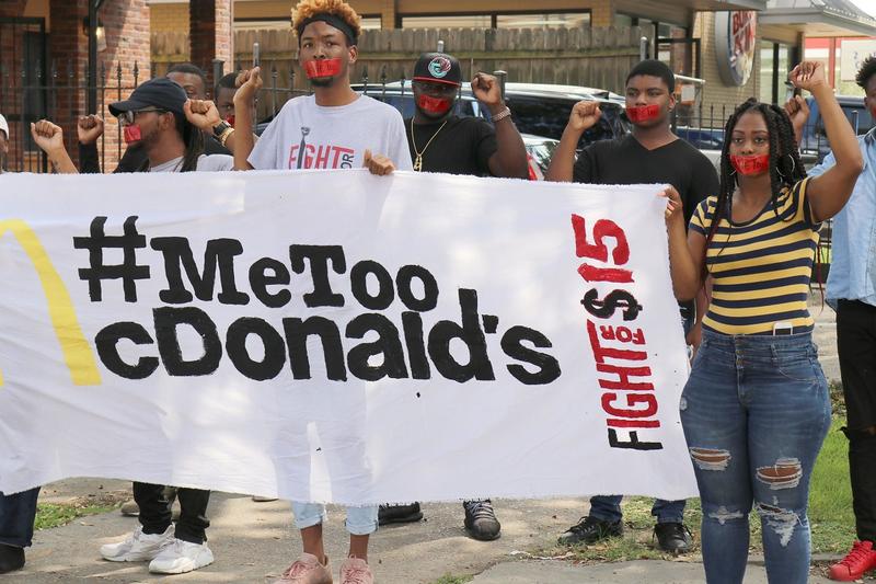 Current and former McDonald's employees wear tape with "#MeToo" over their mouths as they up to one of their restaurants for a protest in New Orleans on Tuesday, Sept. 18, 2018.
