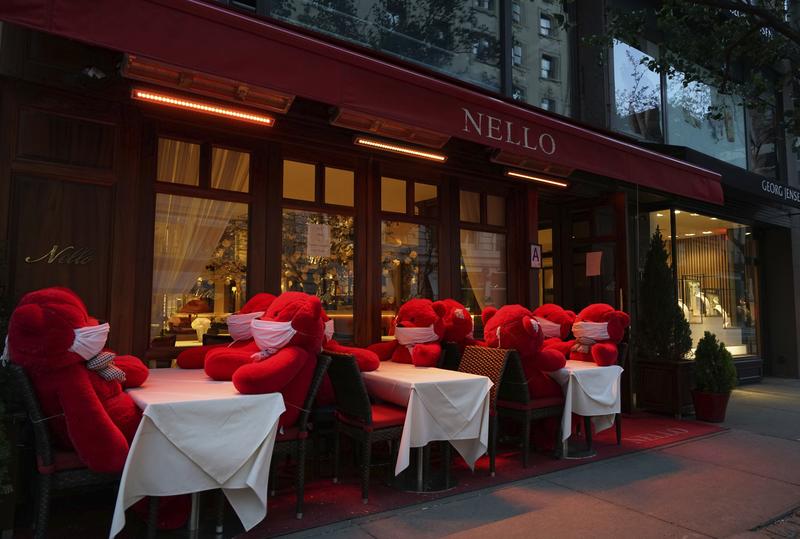 In this Monday, May 4, 2020, photo, stuffed bears in face masks sit at tables on the outdoor patio at the Italian restaurant Nello on Madison Avenue during the coronavirus pandemic in New York. The re