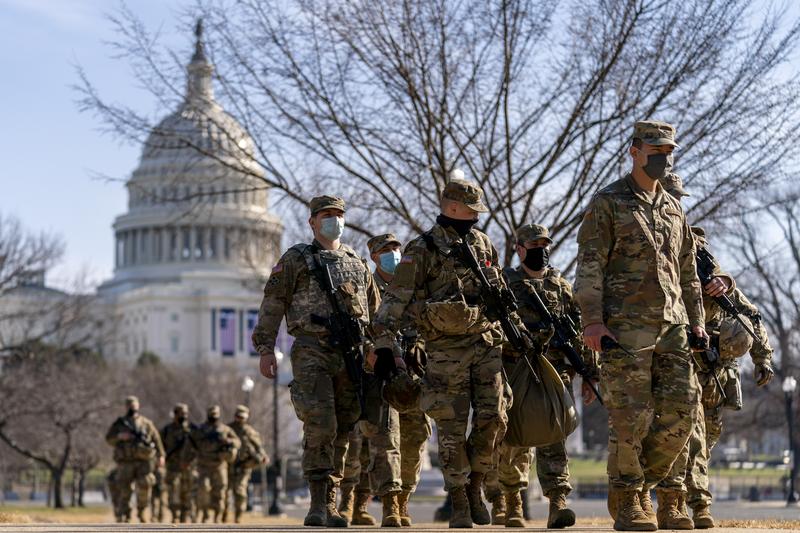 Members of the National Guard patrol outside the Capitol Building on Capitol Hill in Washington, Thursday, Jan. 14, 2021.