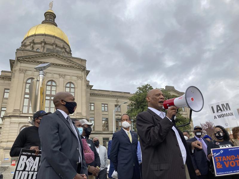 In this March 25, 2021, file photo African Methodist Episcopal Church Bishop Reginald Jackson announces a boycott of Coca-Cola Co. products outside the Georgia Capitol n Atlanta.