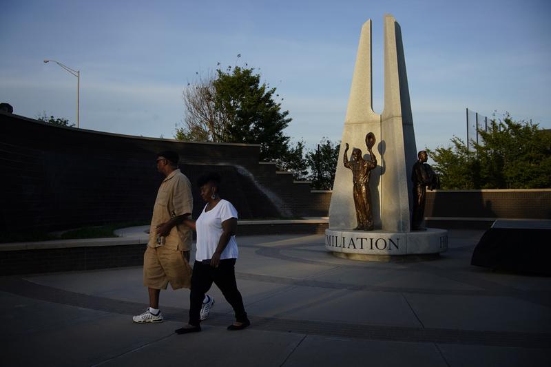Demetrius Boyd, left, and Loretta Boyd visit a sculpture in Tulsa, Oklahoma acknowledging the Tulsa Race Massacre of 1921