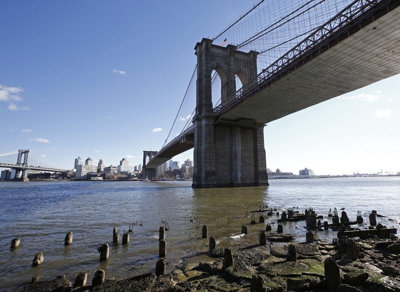 An area between the Brooklyn Bridge, right, and the Manhattan Bridge, upper left, are shown from the East River esplanade, Tuesday, Jan. 19, 2016, in New York.