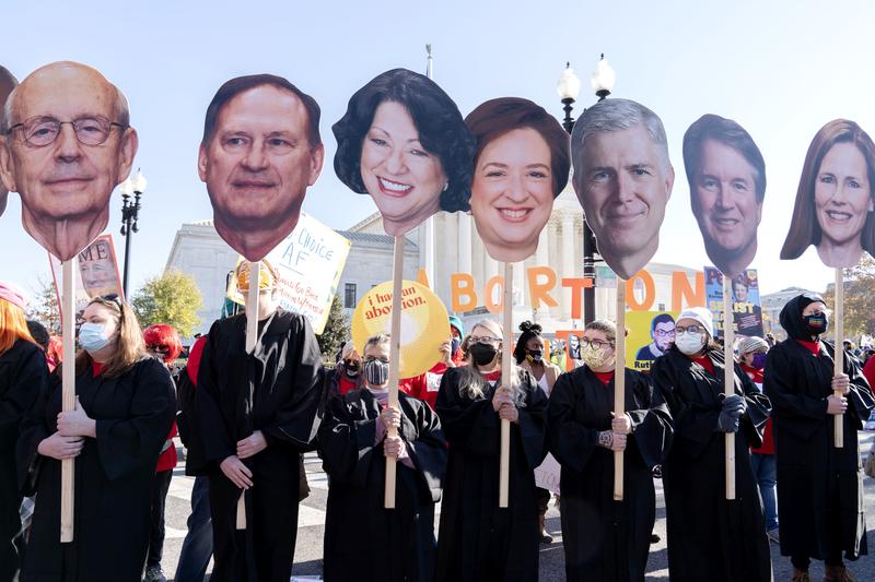 Abortion rights advocates holding cardboard cutouts of the Supreme Court Justices, demonstrate in front of the U.S. Supreme Court Wednesday, Dec. 1, 2021, in Washington.