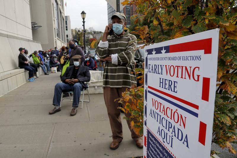Westchester County residents stand in line to vote on the first day of early voting, Saturday, Oct. 24, 2020, in Yonkers, N.Y.