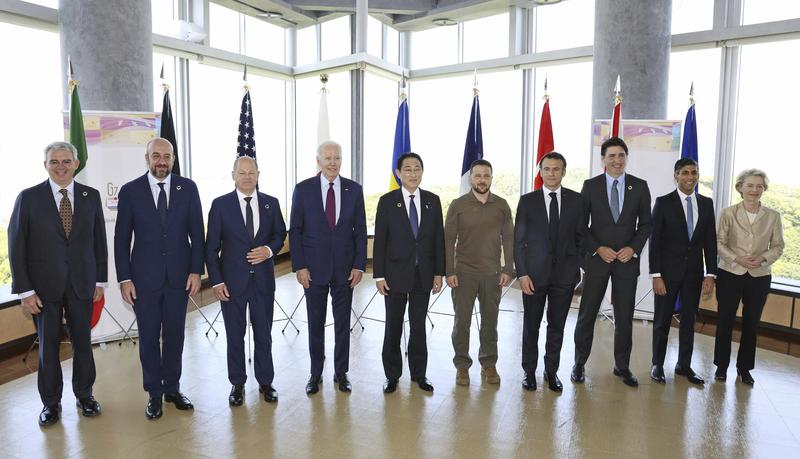 President Joe Biden, fourth from left, and Ukrainian President Volodymyr Zelenskyy, fifth from right, and other G7 leaders pose for a photo before a working session on Ukraine during the G7 Summit in