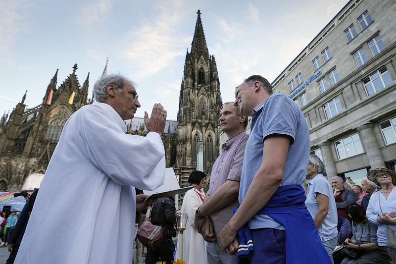 Same-sex couples take part in a public blessing ceremony in front of the Cologne Cathedral in Germany, Sept. 2023. Pope Francis has formally approved allowing priests to bless same-sex couples...