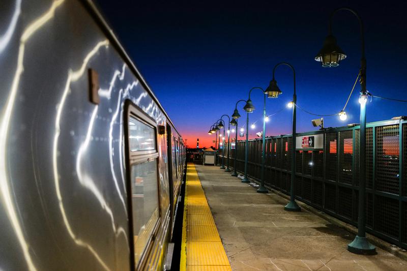 The sunset is seen from the platform of a subway train station in Rockaway in the Queens borough of New York on February 14, 2024.
