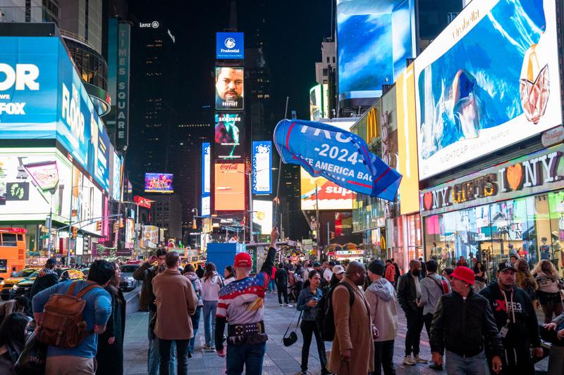 A pro-Trump supporter holds a banner in Times Square on November 5, 2024 in New York City.