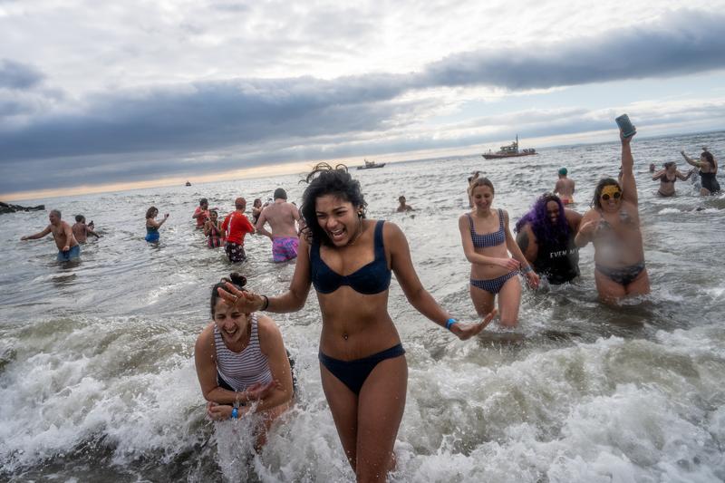 NEW YORK, NEW YORK - JANUARY 1: People participate in the 122nd annual Polar Bear Plunge in Coney Island on January 1, 2025 in the Brooklyn borough of New York City.