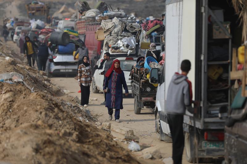 Palestinians, with their personal belongings, wait on the checkpoint as they start to return their home following the ceasefire agreement in Gaza City, Gaza on January 28, 2025.