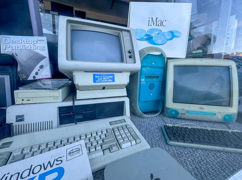 : Old computers including a original 1990s iMac and old PC computers with floppy disc drives are displayed in a computer repair shop on August 13, 2024 in Portland, England.