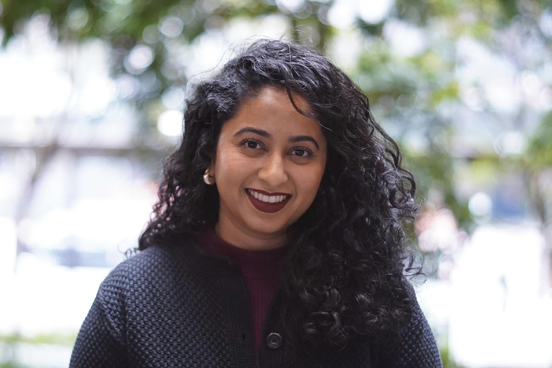 A photograph of producer, Sarah Qari, smiling.