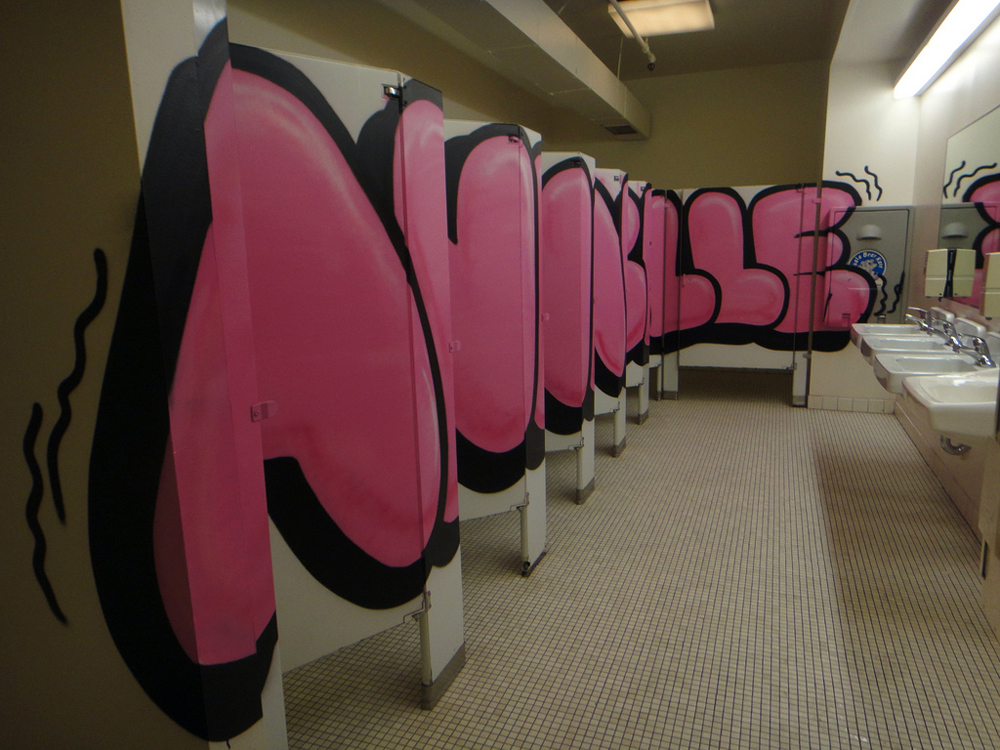 Not even the ladies' room was off-limits to graffiti artists – the museum's bathroom stalls were tagged by French artist André as part of the exhibition. (Photo by Carolina Miranda)