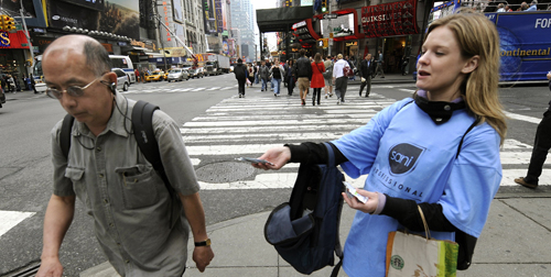 A woman hands out packages of hand sanitizing wipes at Times Square in New York on May 1, to help people take precautions against the spread of the swine flu in the city. (TIMOTHY A. CLARY/AFP/Getty Images)